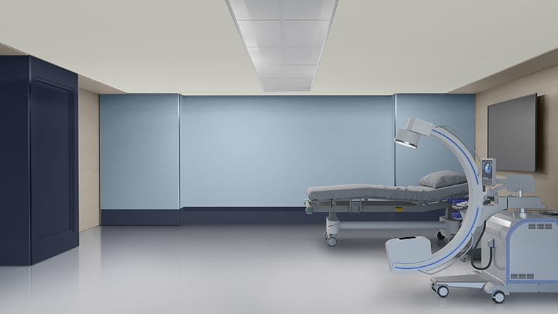 Behandlungsraum mit blauer Rückwand und Krankenhausbett 