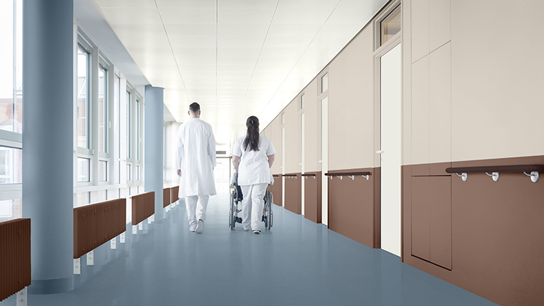 Hospital corridor with blue floor and pillars