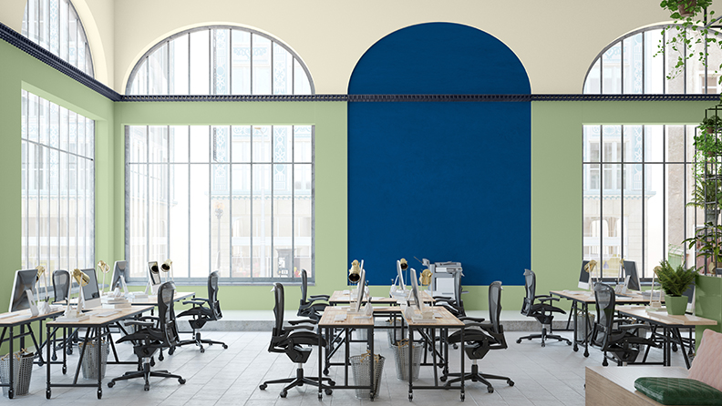 Open-plan office with arched windows, blue arch and green walls