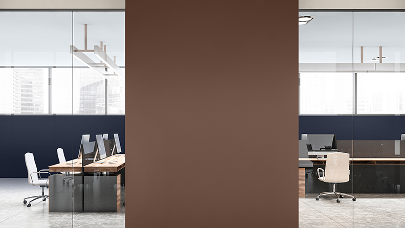 Workspace with rank of desks and brown dividing wall