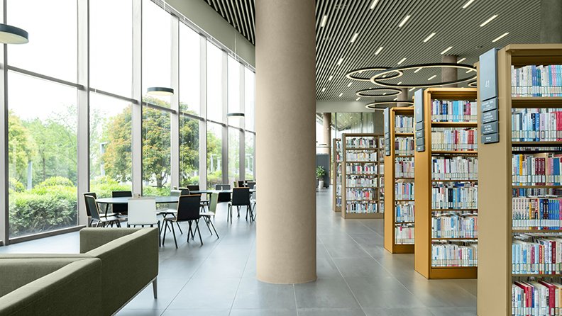 Schulbibliothek mit Fensterwand und gelb gestrichenen Regalen