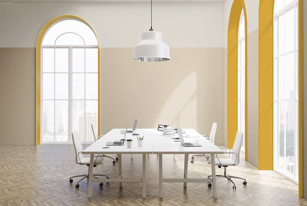 office space with large arch-shaped windows edged in yellow 