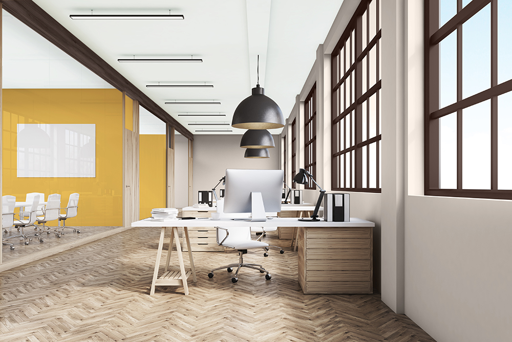 An open workspace with a statement yellow wall 