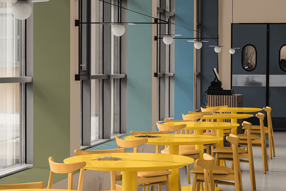 A restaurant with yellow coloured tables and chairs
